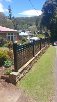 A fence with black slats on it photo