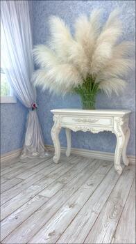 A white table with a vase of flowers on it photo
