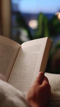 A person reading a book on a couch photo