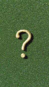 A question mark on a green surface photo