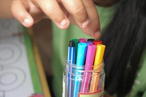 Colorful markers in a jar for creative activities indoors photo