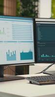 Vertical Empty office space in a multinational company showcases computers with data insights prepared for forecasting and general management. Achieving the business objectives for success. video