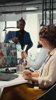 Vertical Employees sharing ideas on a web conference call at the workstation, discussing about project briefing with charts and reports. Business associates attending online meeting event. Camera A. video