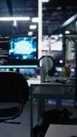 Vertical Computers in data center supporting AI training workflows and automated infrastructure systems. PC screens in high tech facility tracking servers hardware processing machine learning datasets video