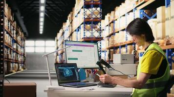 Staff employs software for order processing automation, advanced neural networks brain helps with tracking software in distribution hub. Warehouse with storage racks. Camera A. video