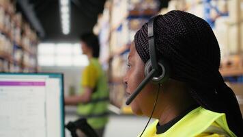 Call center clerk parcel tracking and order dispatch on help line, working in an online shopping logistics center. Worker resolving cargo issues and packages lost in distribution process. Camera A. video