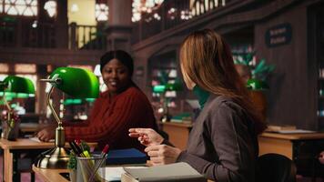 mogna kvinna läsning och använder sig av stryknings penna på tryckt kurser i en offentlig bibliotek under en grön lampa, fokuserade på studerar dokument. memorerande Viktig lektion idéer. kamera a. video