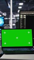Vertical Data center engineer working on neural network software development on chroma key laptop. Server room IT specialist implementing machine learning technology using isolated screen notebook, camera A video