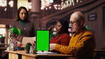 fokuserade olika människor studerar i offentlig bibliotek med grön skärm på pc, forska pedagogisk material och läsning. använder sig av bibliotek Resurser för kurser och skola tentor. kamera b. video