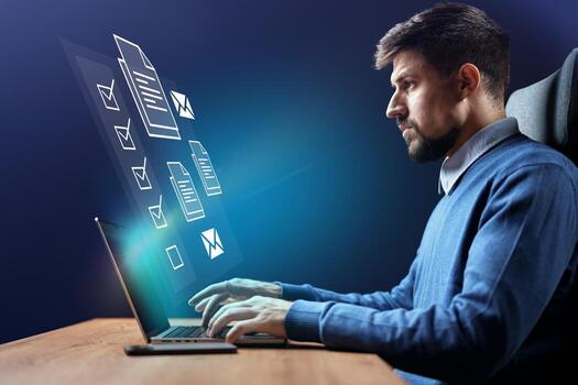Professional man working on a laptop at home while interacting with floating digital documents in a modern workspace setting photo