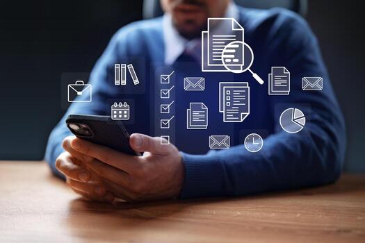 Professional man using smartphone to manage tasks and documents in a modern office environment at evening photo