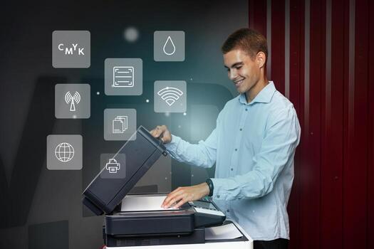 Man operates modern printer in an office setting showcasing various functions during the day photo