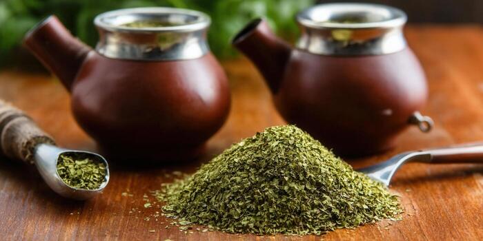 Enjoy a close-up view of yerba mate tea with gourds, and a spoon, ready to be served. photo