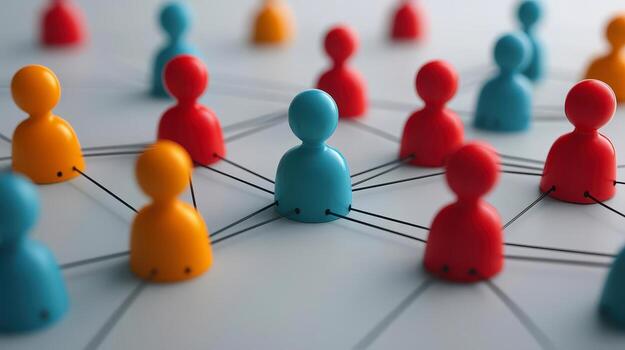 Colorful network of connecting people figurines on a surface. photo