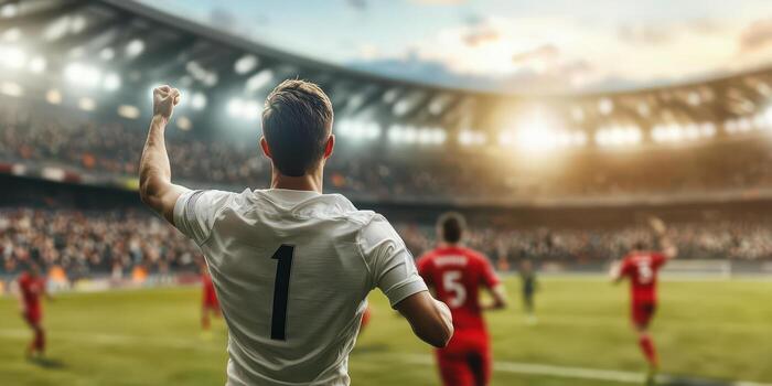 Soccer player celebrating a goal in a vibrant stadium with cheering crowd. photo