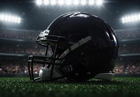 A closeup of a black football helmet on a stadium field at night photo