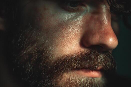 A close up of a man with a beard and a red face photo