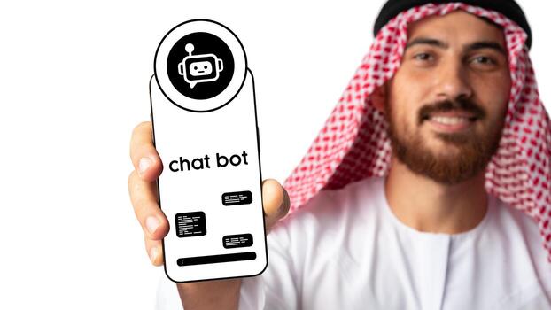Man in traditional attire showcasing a smartphone with a chatbot interface in a modern setting photo