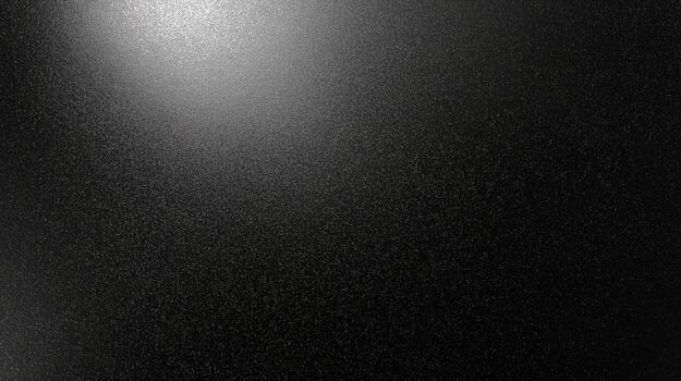Texture of a dark, glossy surface highlighting subtle light reflections and minimal grain patterns photo