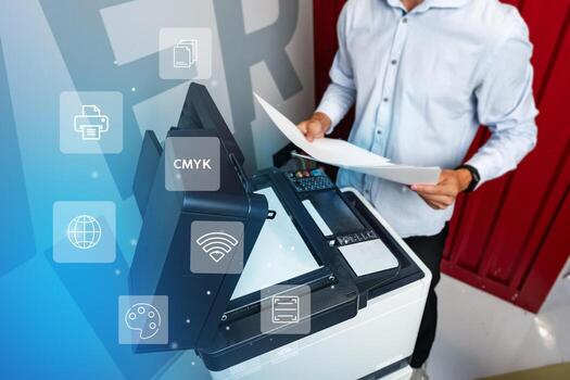 Man operating a modern printer while preparing documents in a creative workspace environment photo