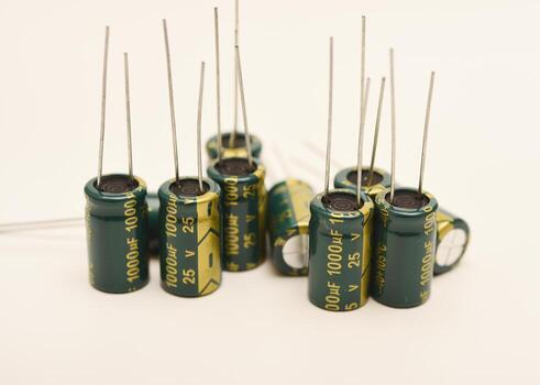 Assorted electrolytic capacitors with various capacitance values. Electronic components for circuit design and energy storage. photo