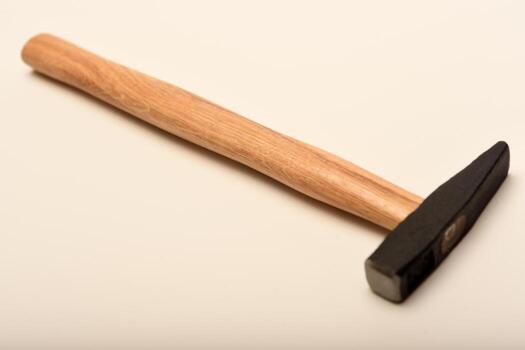 A small hammer with a wooden handle. A hammer on a white background. photo