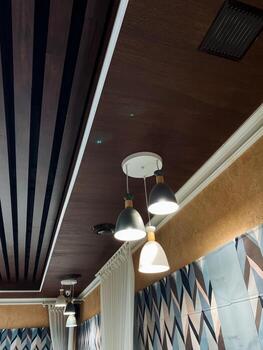 A ceiling adorned with numerous lights elegantly hanging from it, creating a dynamic and visually appealing atmosphere that draws the eye and enhances the rooms overall design photo