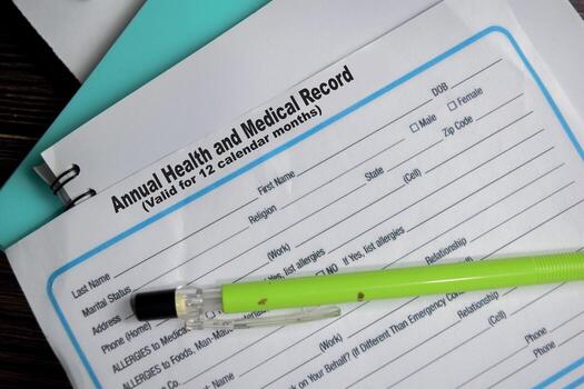 Concept of Annual health and medical records form write on document isolated on Wooden Table. photo