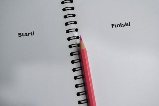 Concept of start and finish write on book isolated on Wooden Table. photo