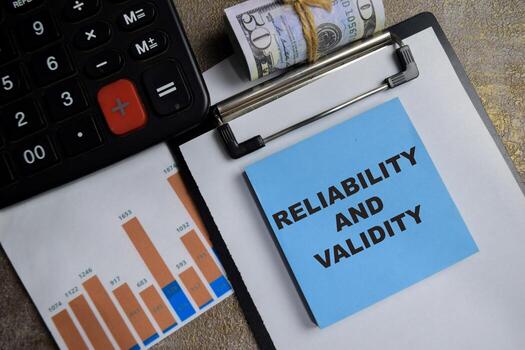 Concept of Reliability and Validity write on sticky notes isolated on Wooden Table. photo