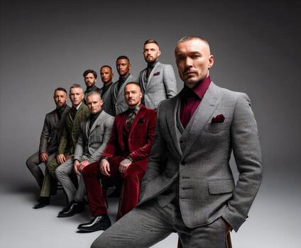 Group of stylish men posing in formal attire indoors photo