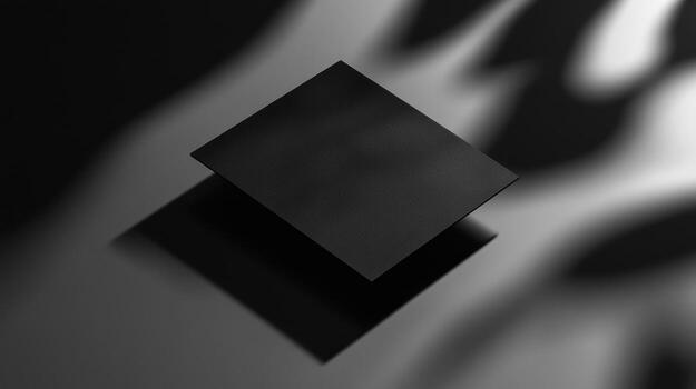 Two square black objects, shadowed and overlapping photo