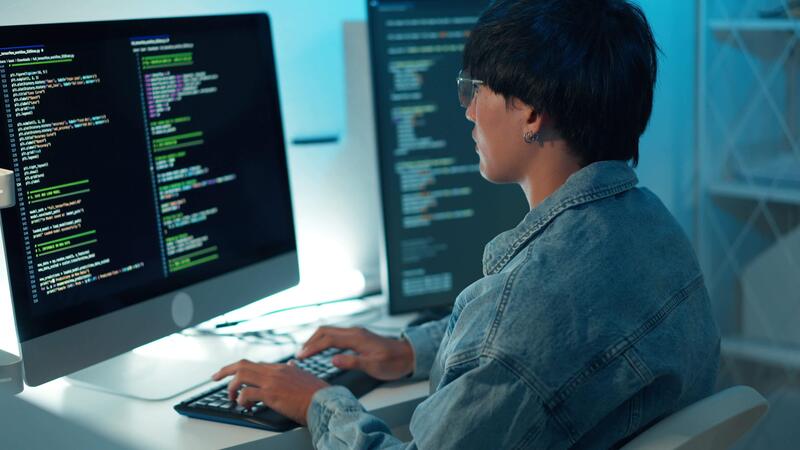 Software developer using keyboard debugging code programming task ...