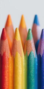 Vibrant macro shot of sharpened colored pencils arranged in rainbow order photo