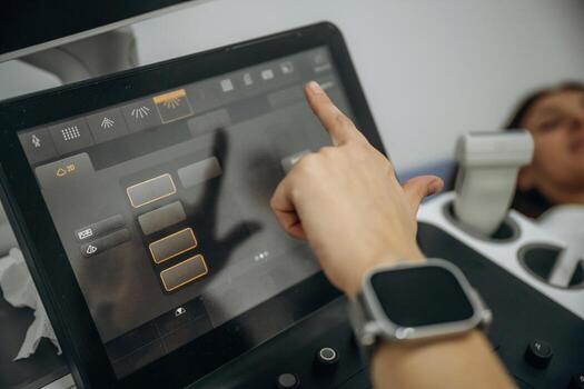 A person using a tablet to control a machine photo