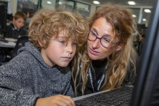 A woman and a child looking at a computer photo