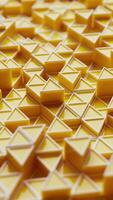 Looped 3D animation with vibrant yellow pyramid shapes in a repeating geometric pattern. Perfect for modern, tech, or abstract backgrounds. video