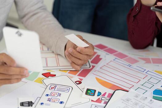 UX and UI Design Process. Team analyzing wireframes and mobile app concepts. photo