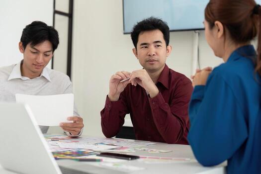 UX and UI Team Discussion. Professionals collaborating on mobile app design concepts. photo