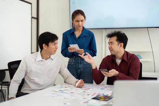 UX and UI Team Discussing Design Concepts in Creative Workspace photo