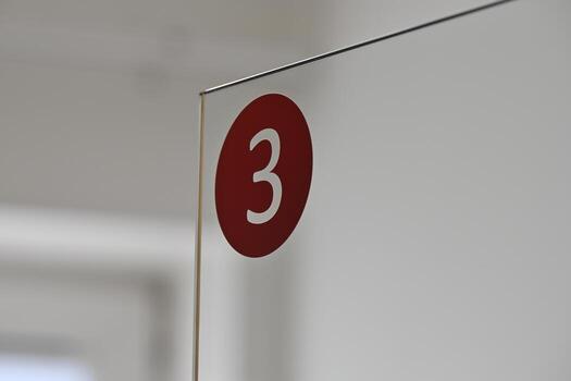 Red Number 3 on Transparent Edge of a Door photo