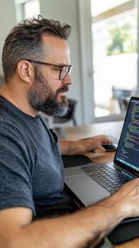 Focused data scientist at desk with jupyter notebook displaying data visualizations and python code. Data scientist photo