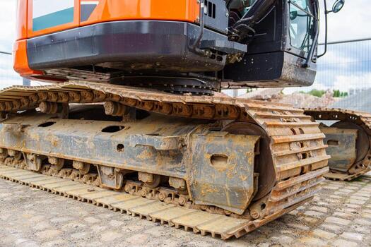 A close-up of a rugged excavator track showcases its durable design and strength. Ideal for construction and engineering projects, representing power and infrastructure development. photo