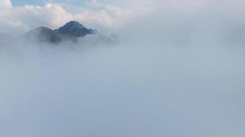 A serene mountain view enveloped in soft mist and dense fog, creating a truly tranquil atmosphere all around video