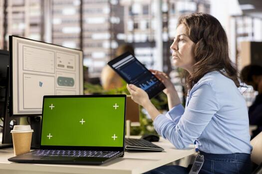 Executive analyst finalizing a report with data analytics next to copy space, developing a project for company development. Professional employee engaged in task management at desk. photo