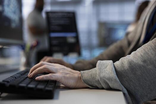 Close up of engineer implementing cybersecurity measures to protect data center assets and information. Man typing on keyboard in server hub, monitoring metrics to enhance operational effectiveness photo