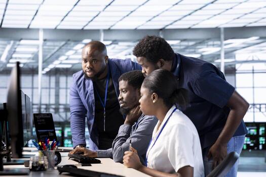 Team of data center office computer scientists using programming languages to construct algorithms and build applications. Teamworking server farm IT specialists debugging and optimizing code photo