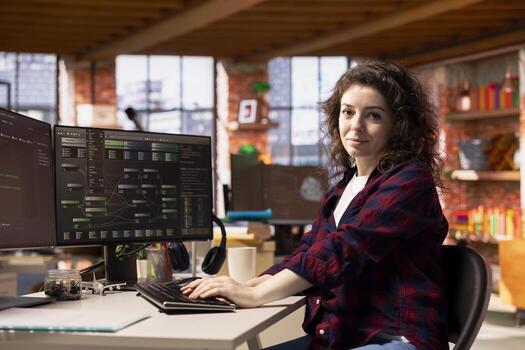 Portrait of smiling programmer coding advanced AI algorithm in startup workspace, refining machine learning models to enhance automation. Happy woman using coding platform in Silicon Valley office photo