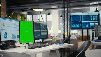 Modern empty office displays green screen on tablet at workstation, space prepared for professional administration and performance analysis to enhance business management and project success. video