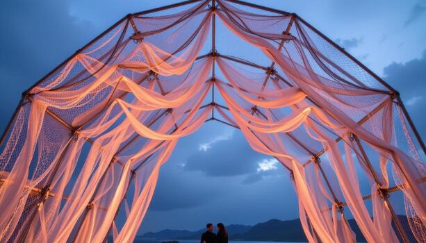 a geometric metal arch draped with mesh fabric, soft neon glows, and abstract suspended forms. photo